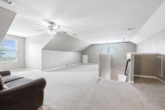 sitting room with ceiling fan, vaulted ceiling, and light carpet