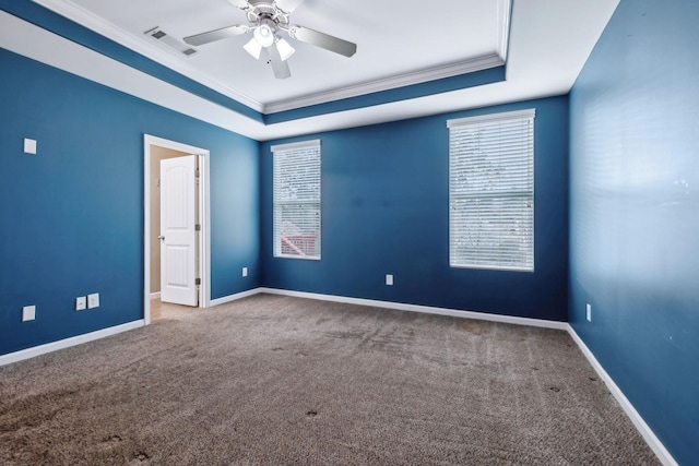 unfurnished room with crown molding, ceiling fan, a tray ceiling, and carpet flooring