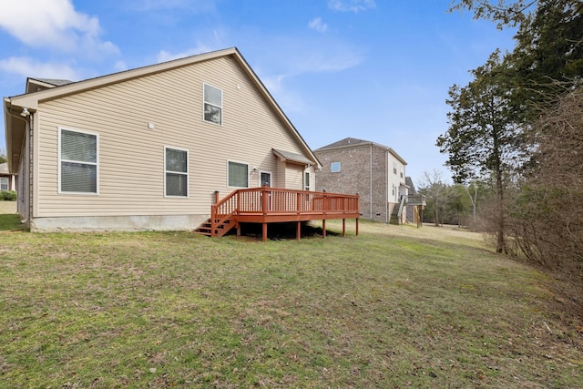 rear view of property with a yard and a deck