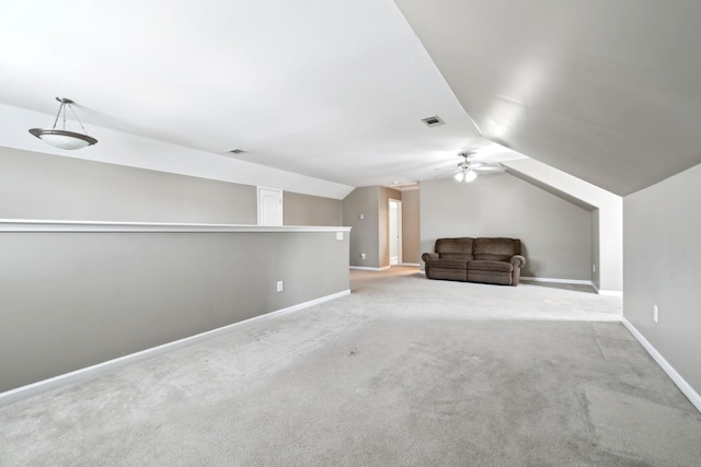 additional living space featuring vaulted ceiling and light carpet