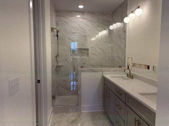 bathroom featuring double vanity, marble finish floor, a marble finish shower, and a sink