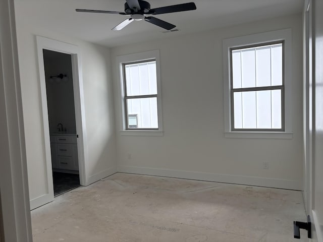 unfurnished bedroom with a ceiling fan, visible vents, ensuite bath, and baseboards