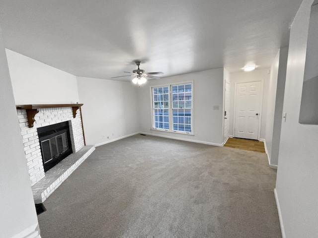 unfurnished living room with a fireplace, ceiling fan, and carpet flooring