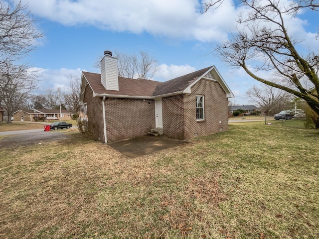 rear view of property with a lawn