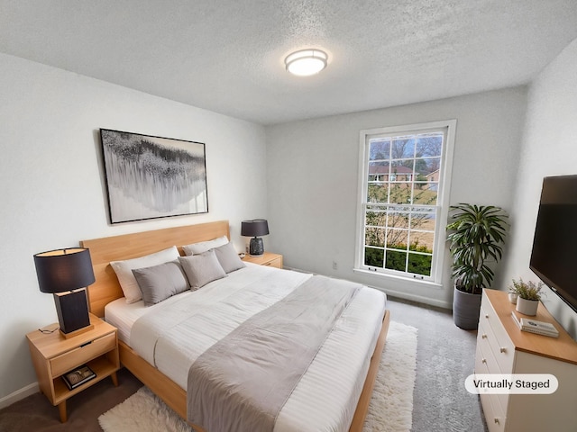 bedroom with carpet floors and a textured ceiling