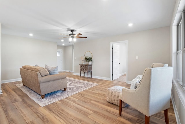 living room with ceiling fan and light hardwood / wood-style floors