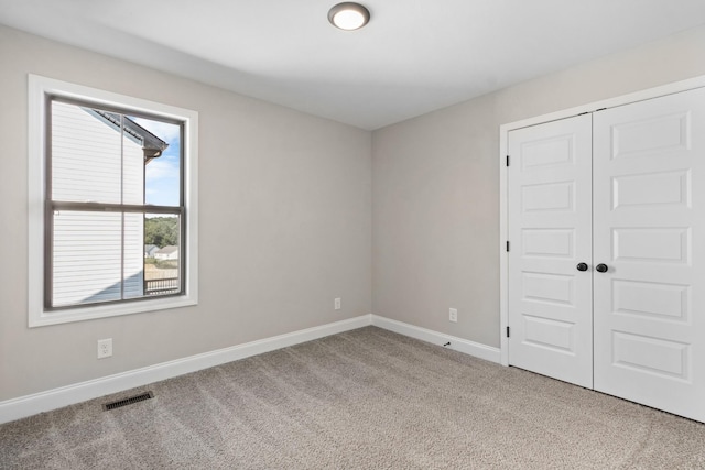 unfurnished room with light carpet