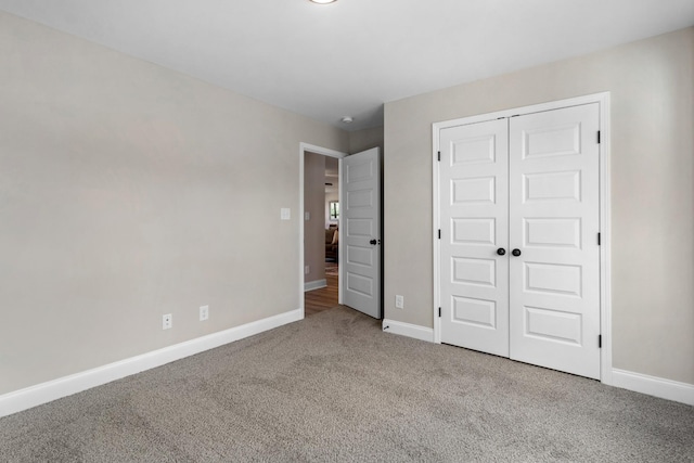 unfurnished bedroom featuring carpet flooring and a closet