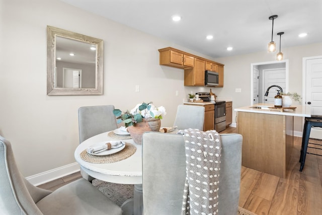 dining area featuring light hardwood / wood-style floors and sink