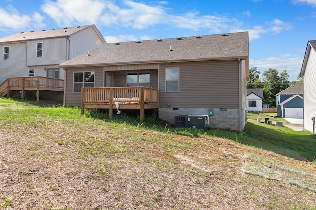 back of property featuring central AC, a wooden deck, and a lawn