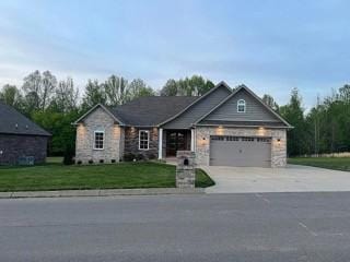 craftsman house featuring a garage and a front yard