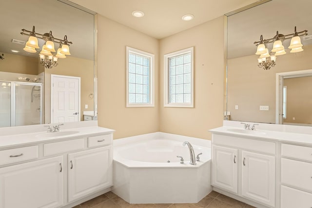 bathroom with plus walk in shower, tile patterned floors, an inviting chandelier, and vanity