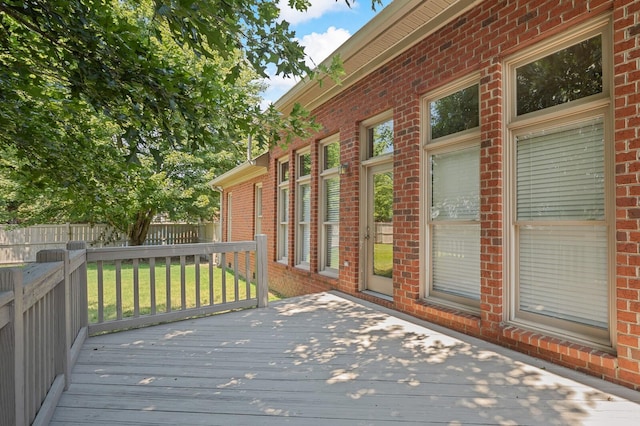 wooden deck featuring a yard