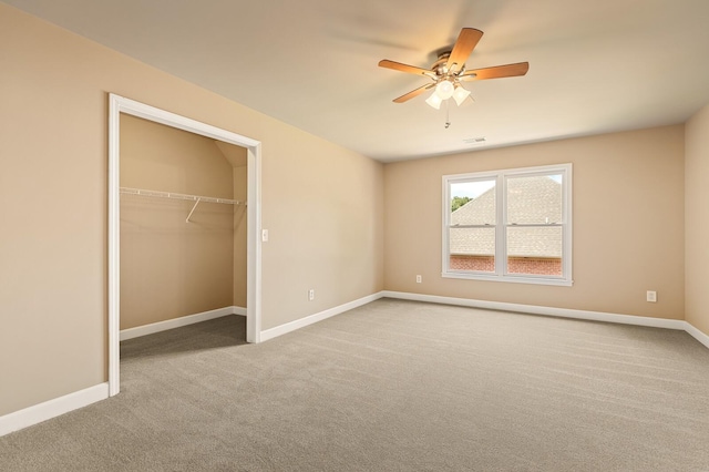 unfurnished bedroom featuring ceiling fan, a closet, and light carpet