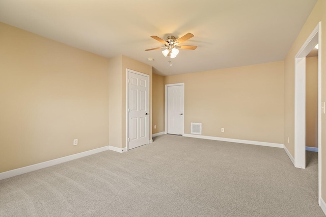 carpeted empty room featuring ceiling fan