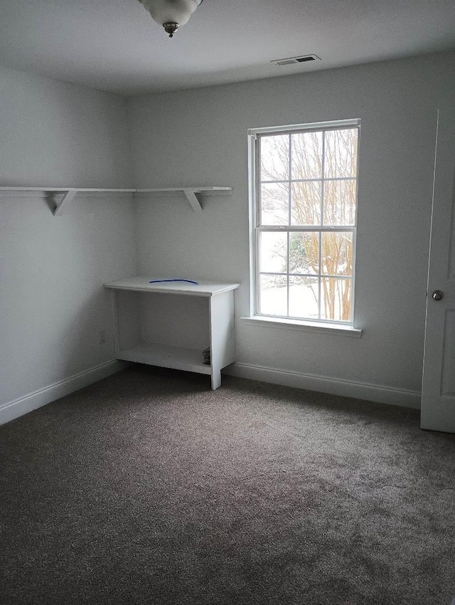 interior space featuring carpet floors, visible vents, and baseboards