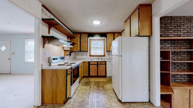 kitchen featuring sink, a textured ceiling, and white appliances