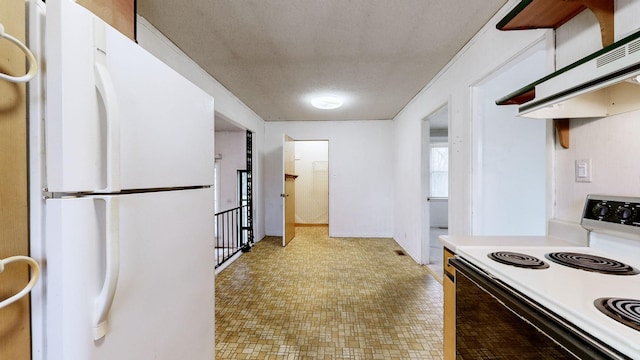 kitchen featuring white fridge and electric range oven