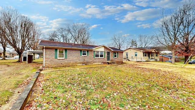 rear view of house featuring a yard and a carport