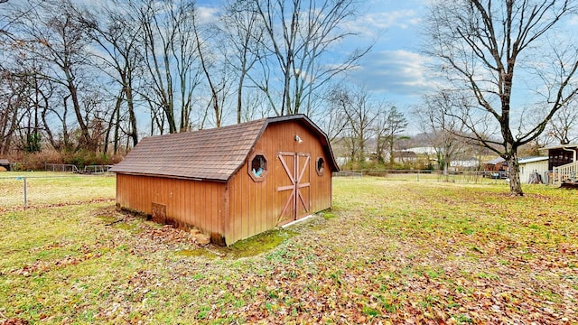 view of outbuilding featuring a yard