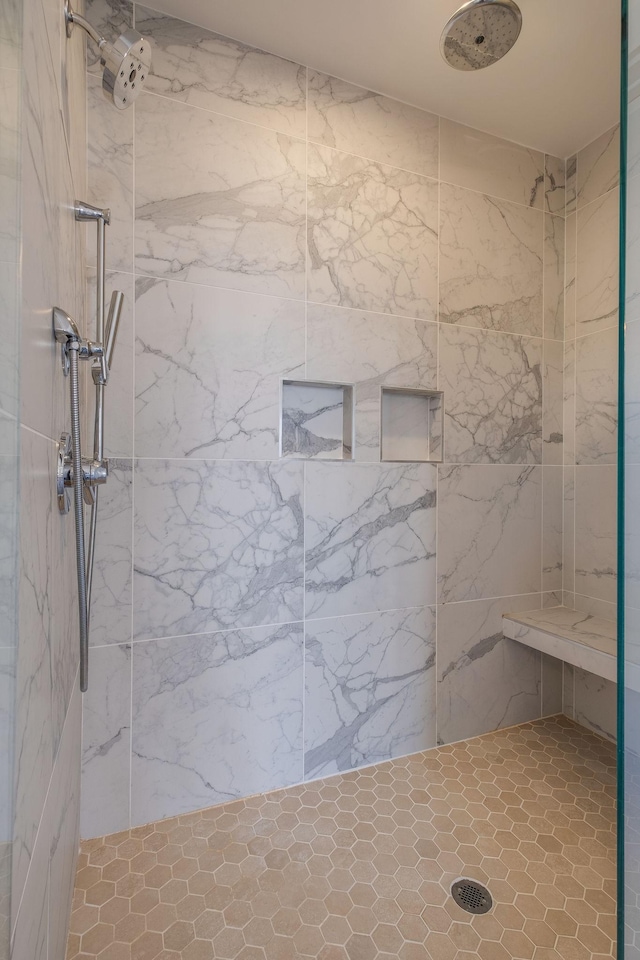 bathroom with tiled shower