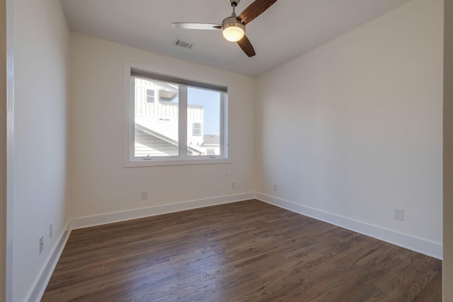 empty room with ceiling fan and dark hardwood / wood-style floors