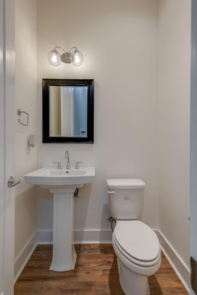 bathroom with wood-type flooring and toilet