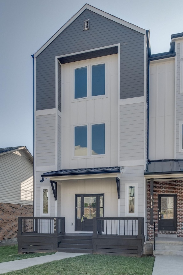 back of property featuring covered porch