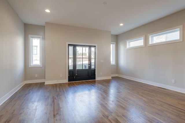 foyer with a wealth of natural light and dark hardwood / wood-style floors