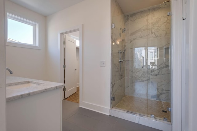 bathroom featuring vanity and a shower with door