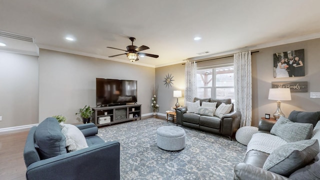 living room with hardwood / wood-style floors, crown molding, and ceiling fan