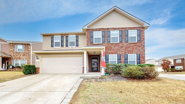 view of front of property with a garage and a front lawn