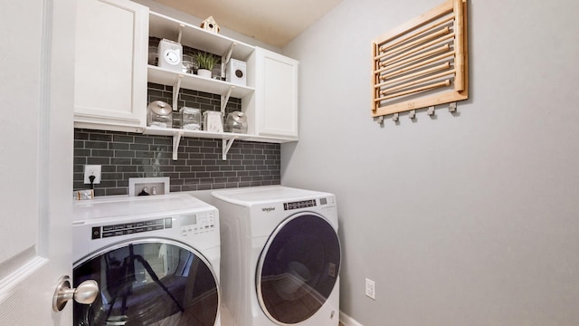 laundry area featuring cabinets, separate washer and dryer, and radiator