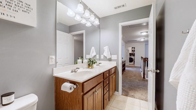 bathroom featuring tile patterned floors, toilet, washer / dryer, and vanity