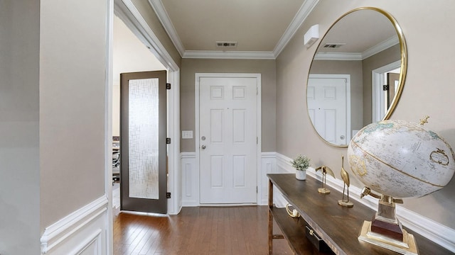 foyer entrance featuring crown molding and dark hardwood / wood-style flooring