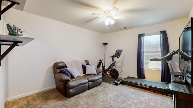 workout area with ceiling fan and carpet