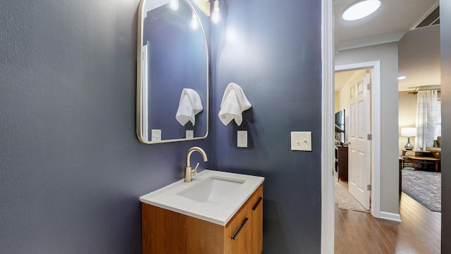 bathroom with hardwood / wood-style flooring and vanity