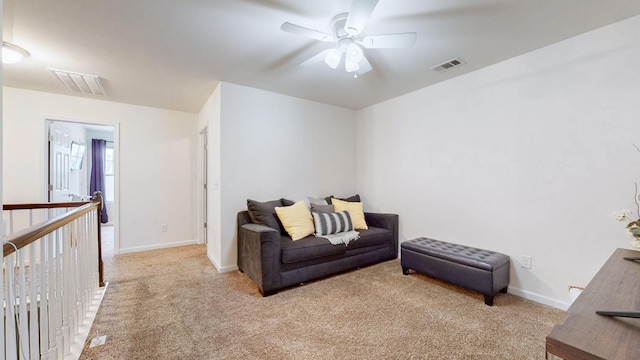 sitting room with light colored carpet and ceiling fan