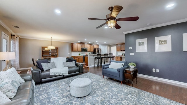 living room featuring crown molding, dark hardwood / wood-style floors, and ceiling fan