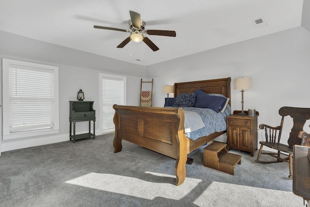 bedroom featuring ceiling fan and carpet