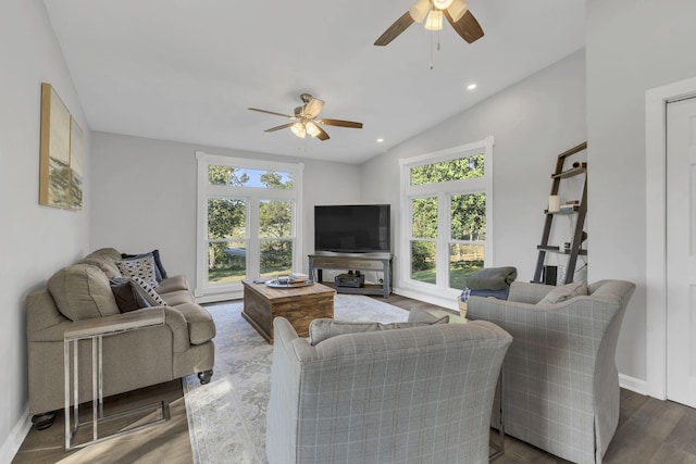 living room featuring vaulted ceiling, dark hardwood / wood-style floors, and ceiling fan