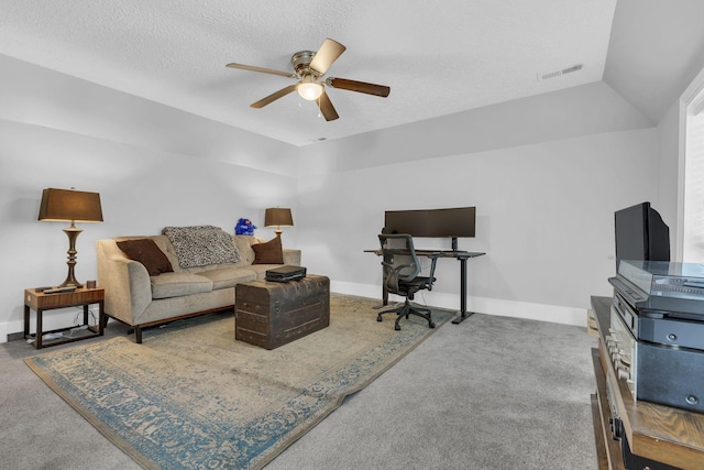 living room featuring a textured ceiling, vaulted ceiling, ceiling fan, and carpet