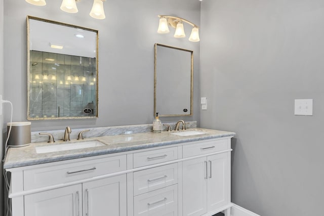 bathroom with vanity and a shower with door