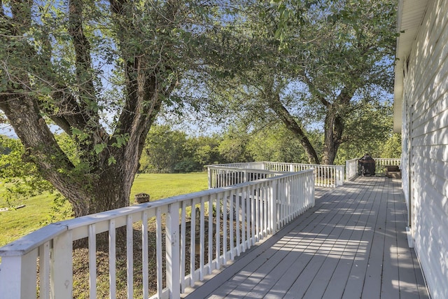 wooden terrace with a lawn