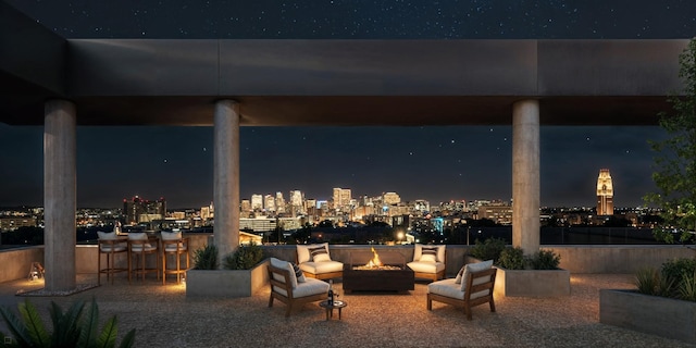 patio at twilight with an outdoor living space with a fire pit and a bar