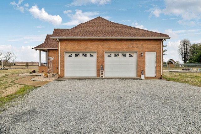 view of side of home featuring a garage and an outdoor structure