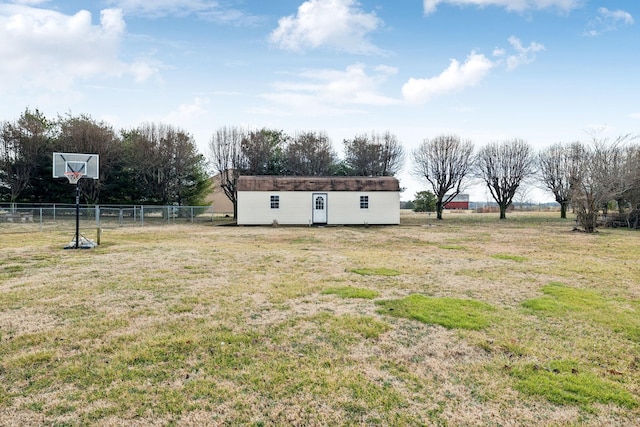 view of yard featuring a rural view and an outbuilding