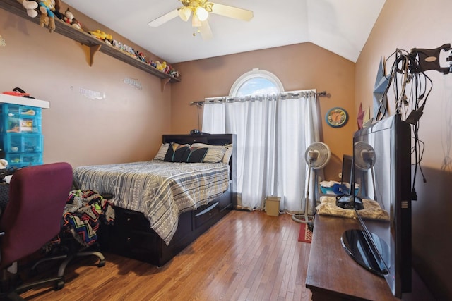 bedroom featuring ceiling fan, lofted ceiling, and hardwood / wood-style floors