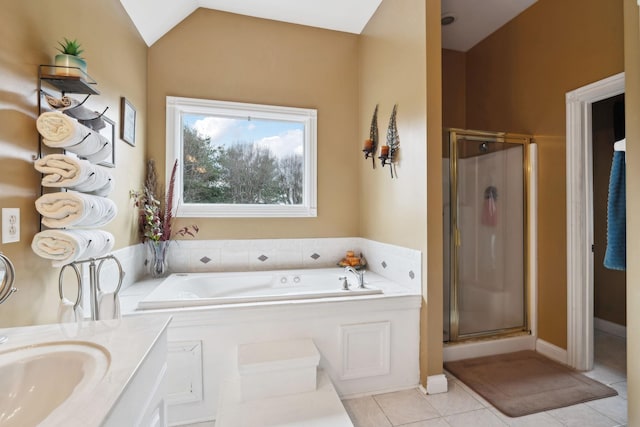 bathroom featuring tile patterned floors, independent shower and bath, vaulted ceiling, and vanity