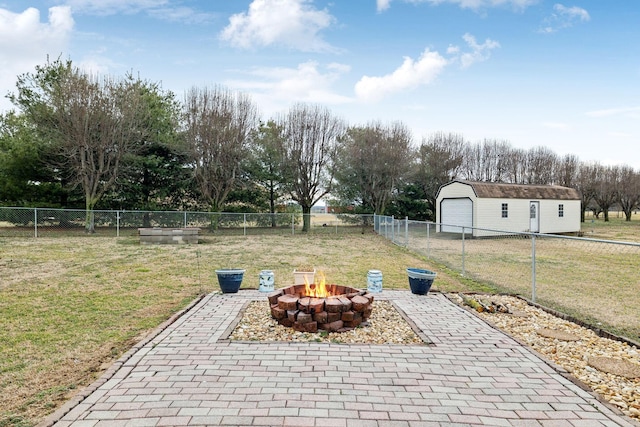 view of patio with an outbuilding, an outdoor fire pit, and a garage